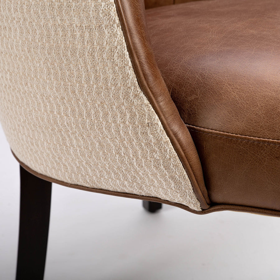Goodman brown leather chair with curved back, textured woven fabric outside back. Closed up bottom and back view.