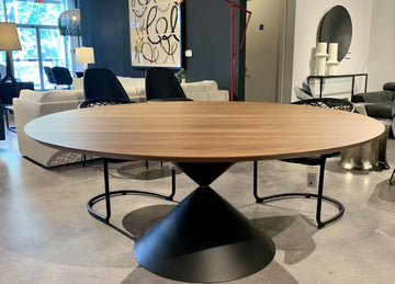 Fixed round Clessidra Dining Table with solid black steel base and wooden top.