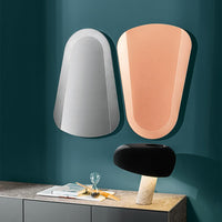 A blue and an orange Clessidra mirrors placed in a different ways.