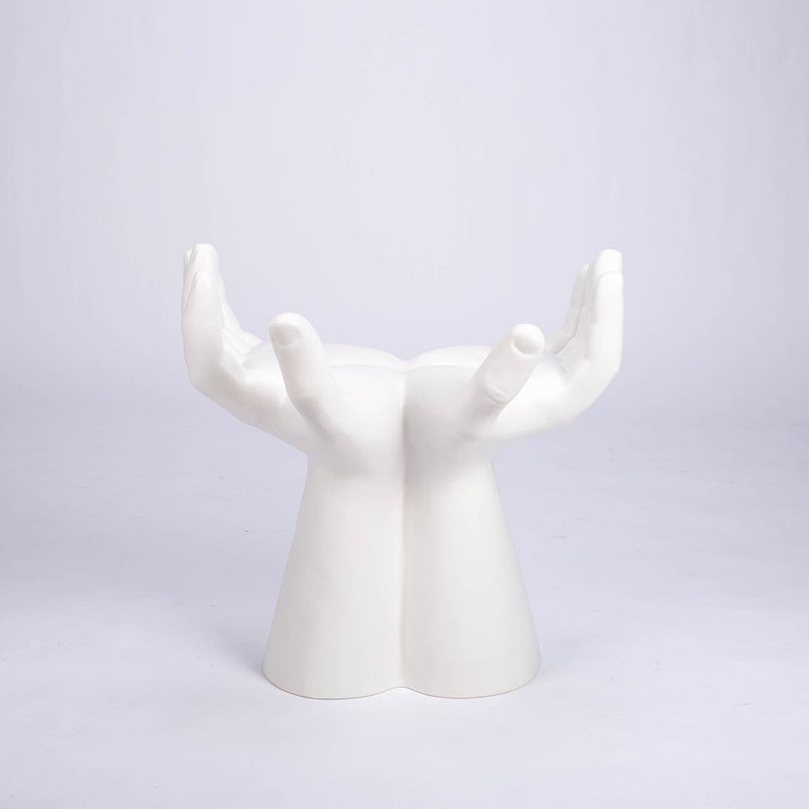 Sculptured stool that looks like two hands with opened palms for seating area made in white matte finish.