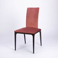A red four seasons dining chair crafted from solid beechwood. Front and side view.