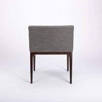 A grey four seasons dining chair crafted from solid beechwood. Back view.