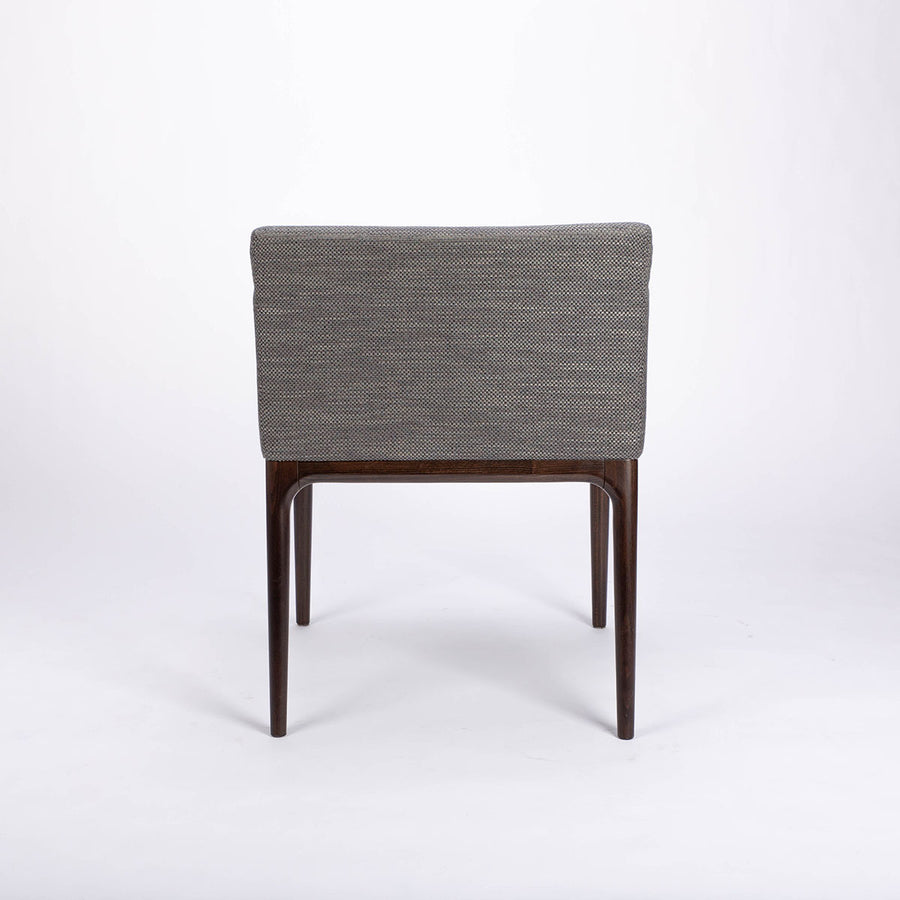 A grey four seasons dining chair crafted from solid beechwood. Back view.