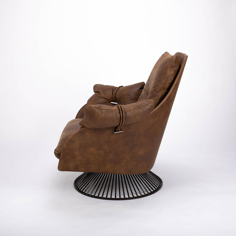 A brown modern and luxury leather armchair with glossy spoked base anchors. Side view.