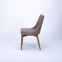 Calais Side dining chair with curved back and arms and the solid ash frame. Side view.