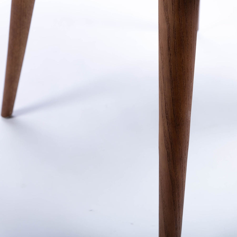 Calais Side dining chair with curved back and arms and the solid ash frame. Closed up view of legs.