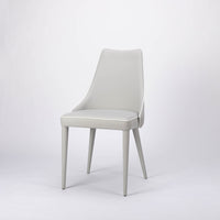 Clara side dining chair completely in white color with curved back tapers and wraps.