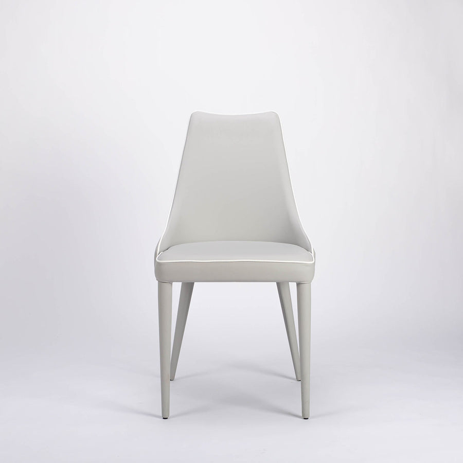 Clara side dining chair completely in white color with curved back tapers and wraps, front view.