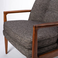 Draper Lounge Chair in midcentury modern classic design with a solid walnut external frame, a steam-bent plywood interior frame and sumptuous tailored upholstery, grey color, closed up view of seat.