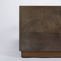 Brown Cabo Cocktail Table block shaped in an abstract metal material, closed up view.