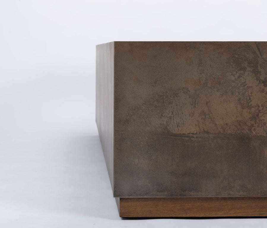 Brown Cabo Cocktail Table block shaped in an abstract metal material, closed up view.