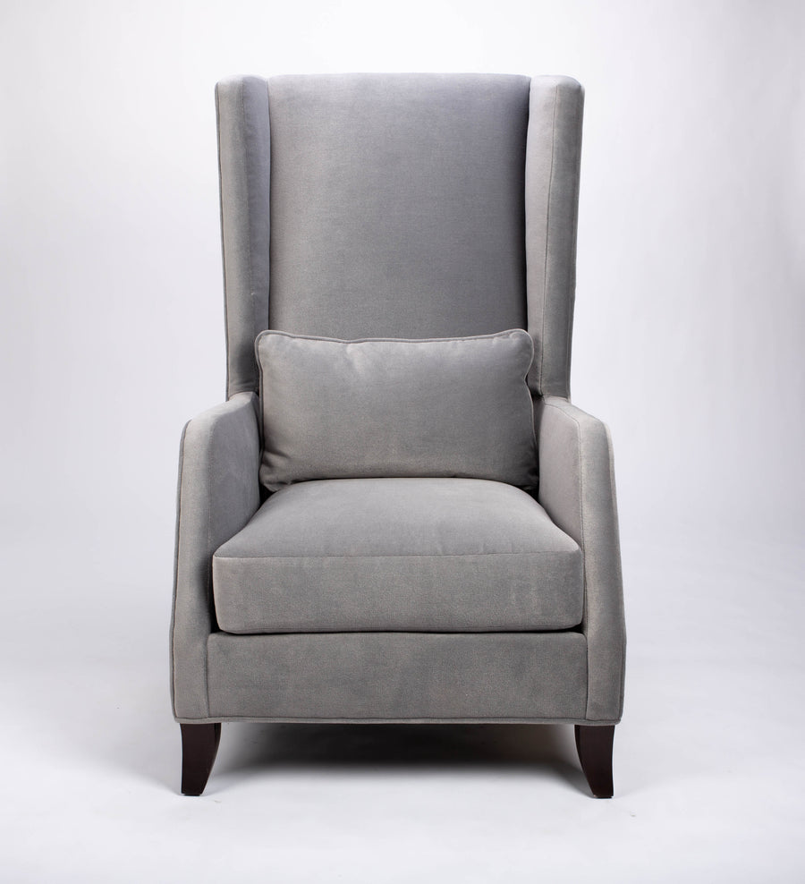 A light grey Rob lounge chair with extra high back, subtle angles and clean shape in the wing detail, front view.