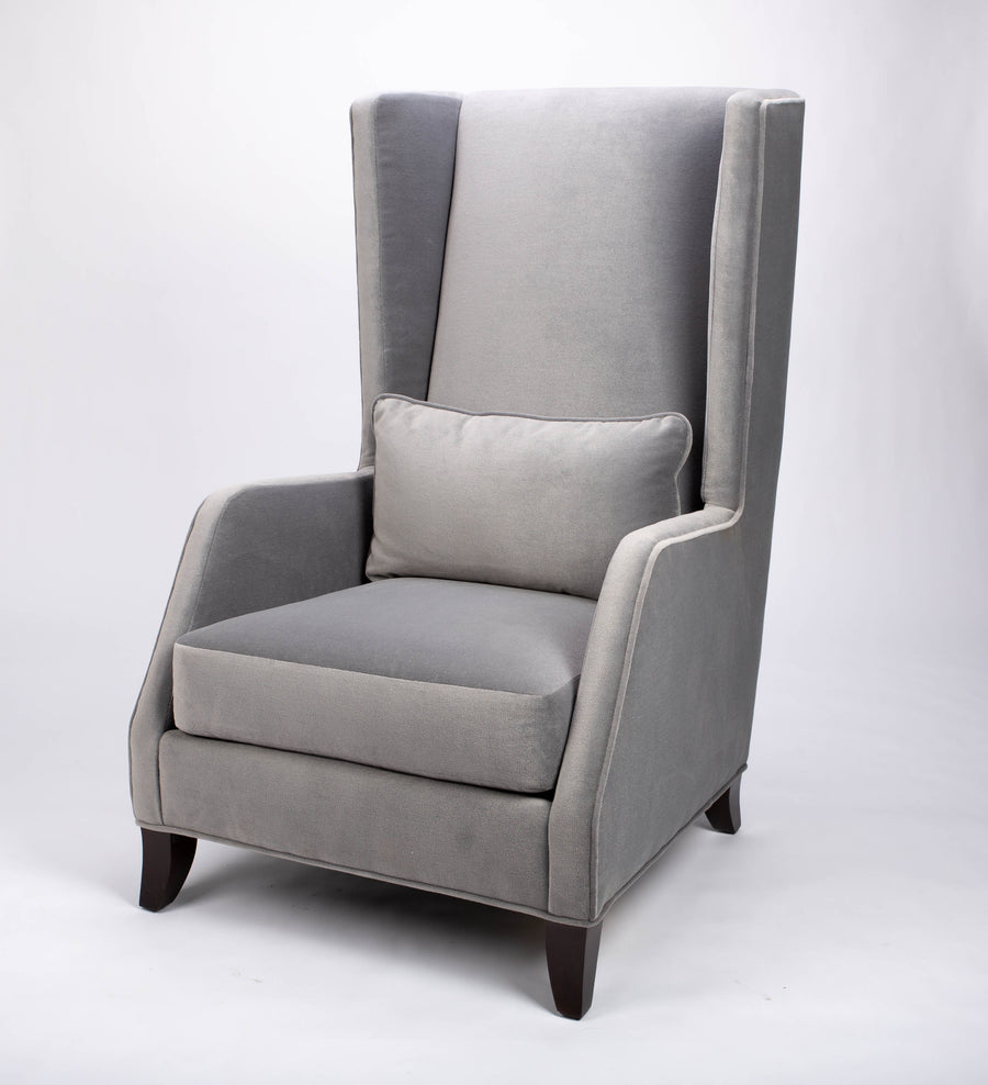 A light grey Rob lounge chair with extra high back, subtle angles and clean shape in the wing detail.