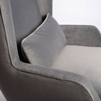 A light grey Rob lounge chair with extra high back, subtle angles and clean shape in the wing detail, closed up seat view.