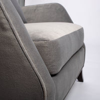 A light grey Rob lounge chair with extra high back, subtle angles and clean shape in the wing detail, closed up bottom view.