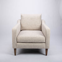 A white fabric Tea lounge stocked chair, front view.