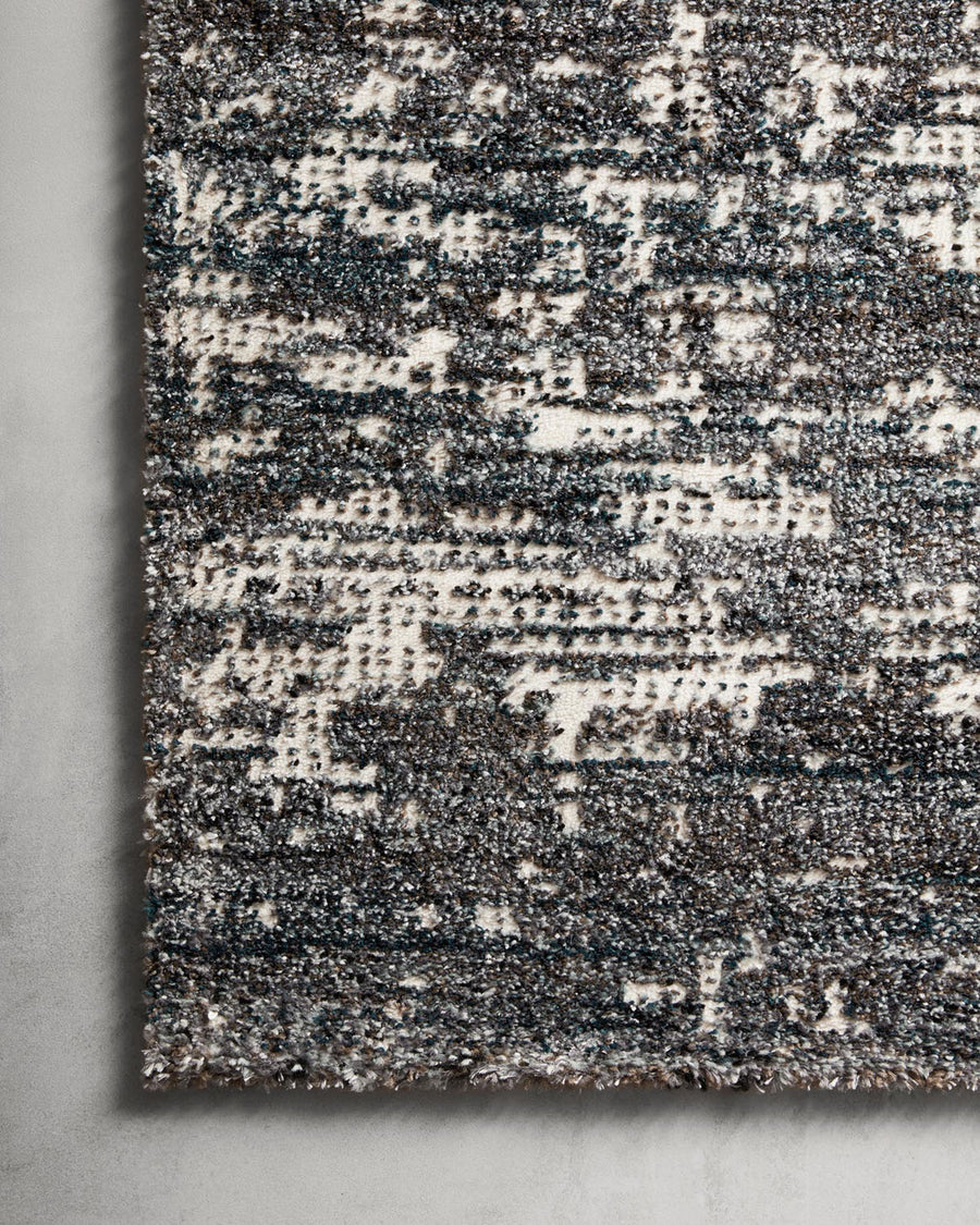 Augustus Denim Area Rug of polypropylene and polyester presents abstract display of sloping banks amidst earthy swaths of color.