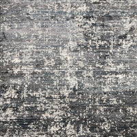 Augustus Denim Area Rug of polypropylene and polyester presents abstract display of sloping banks amidst earthy swaths of color.