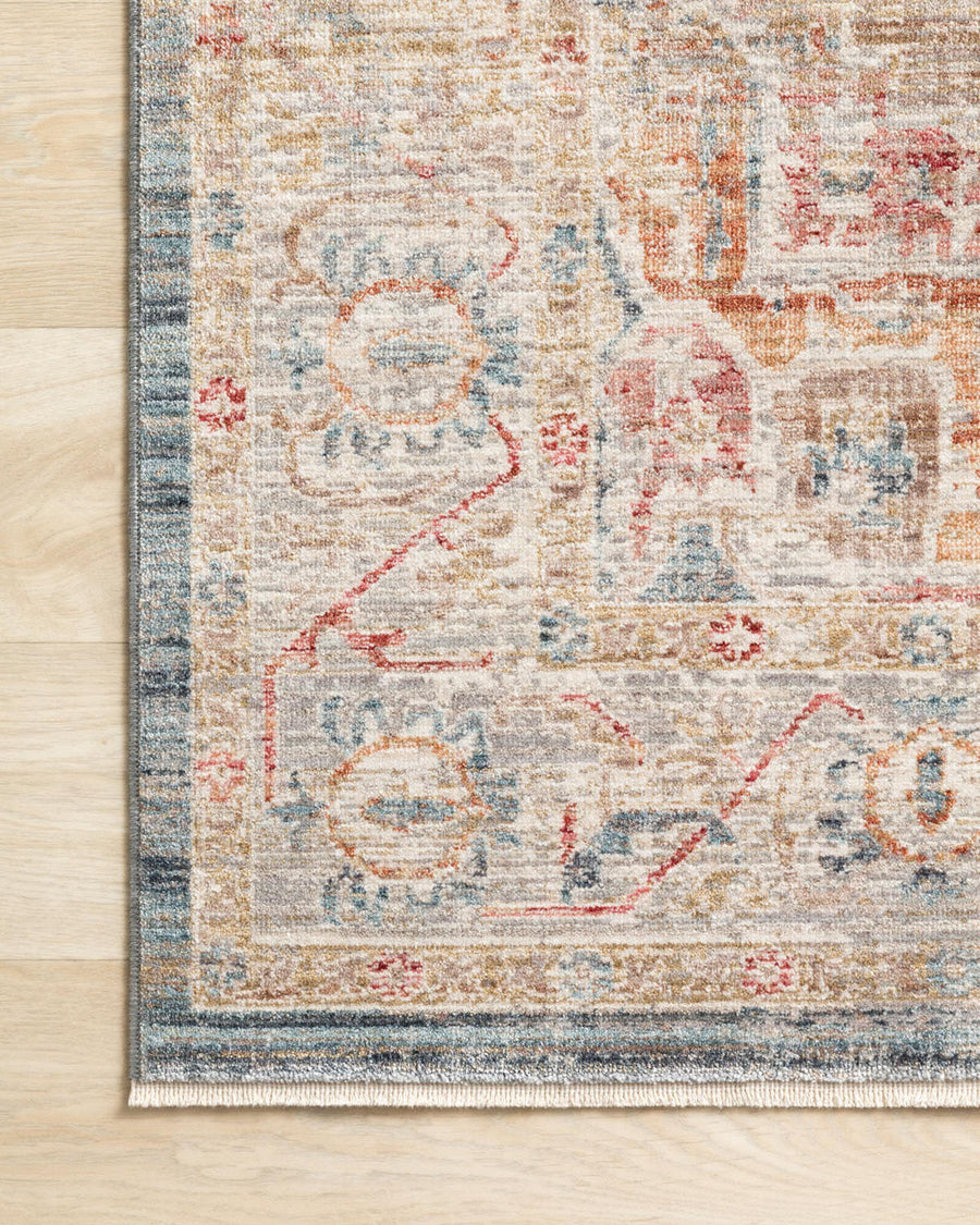 Claire Blue + Multi Area Rug power-loomed of polyester pile with a beautiful color palette and a mix of abstract and traditional-inspired motifs.