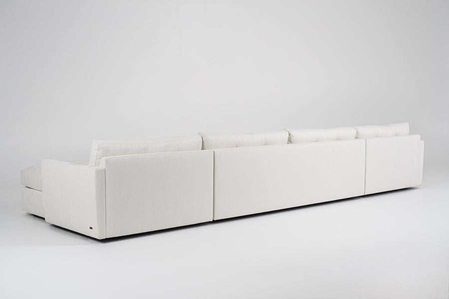 Large white u-shaped Carmet Sectional with sleek track arms. Back view.