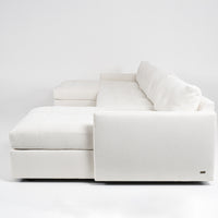 Large white u-shaped Carmet Sectional with sleek track arms. Side view.