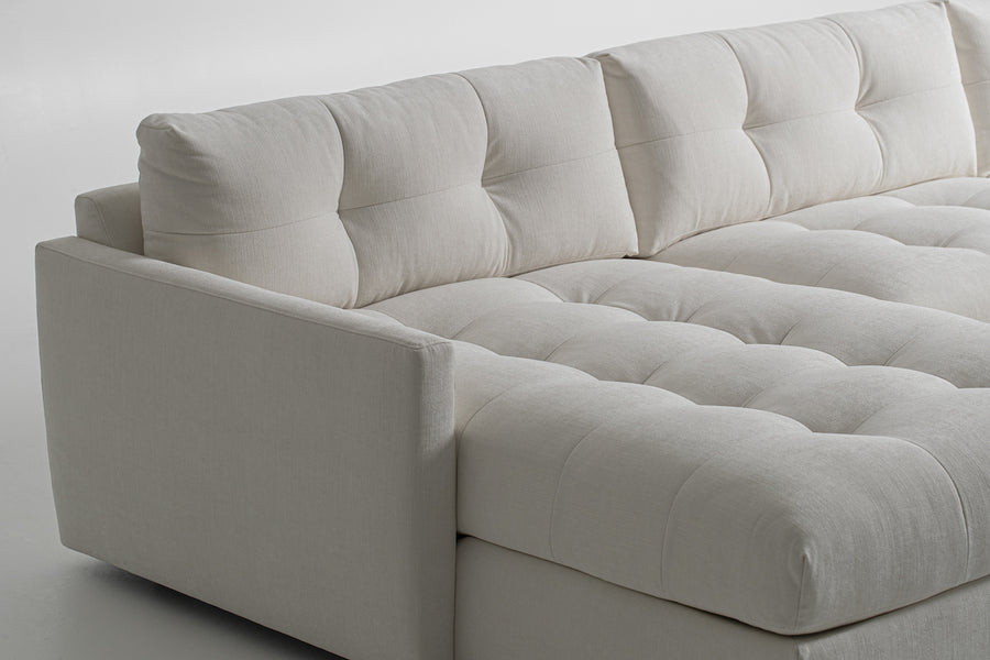 Large white u-shaped Carmet Sectional with sleek track arms. Closed up side view.