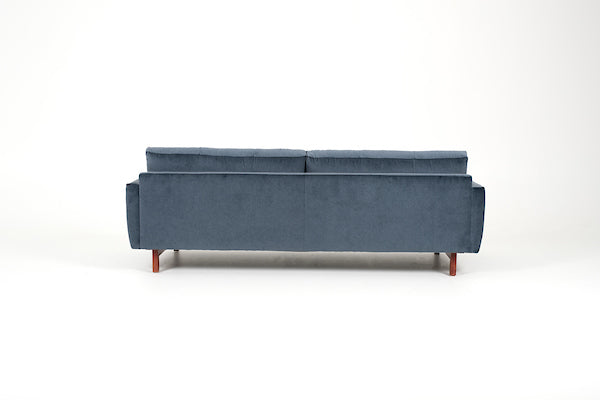 Blue two seat Carmet sofa by American Leather with modernist track arms that taper in from the top of the sofa to the bottom. Back view.