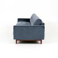 Blue two seat Carmet sofa by American Leather with modernist track arms that taper in from the top of the sofa to the bottom. Side view.
