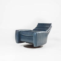 A blue Lanier leather recliner chair with the shape of classic automotive designs, reclined.