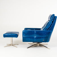 A blue leather recliner chair with four star base and ottoman, side view.