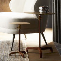 Brown Addison Accent Table made of leather and metal with bi-tonal finished brass and top with brushed finish. Placed in a modern room next to a white chair.