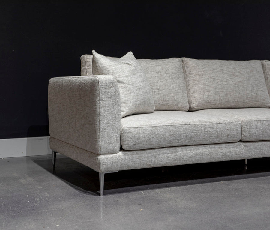 Dania three seat sofa with slender tapered aluminum legs and a long low profile, high end seating comfort and expert tailoring.