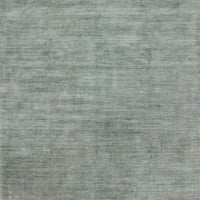 Hand-loomed Elliot Aqua + Slate Area Rug from viscose from bamboo and wool.