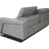 Beige leather Focus sofa with medium soft seat with stitching detail and metal detail on the outside arm. Back view.