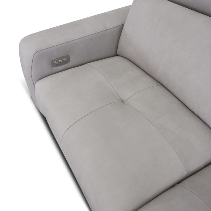 Beige leather Focus sofa with medium soft seat with stitching detail and metal detail on the outside arm. Closed up seat view.