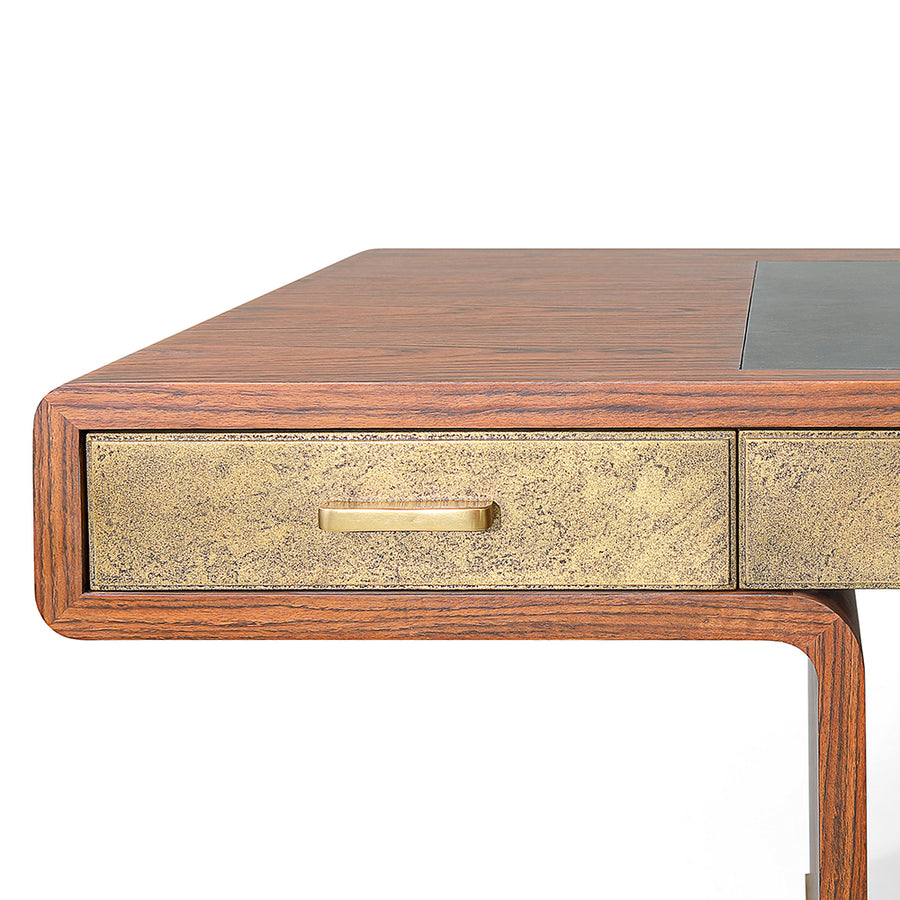 Three drawer Fonda Desk made in oiled African Walnut with a Black Vellum top panel and brass drawers, handles and feet. Closed up view on a left drawer.