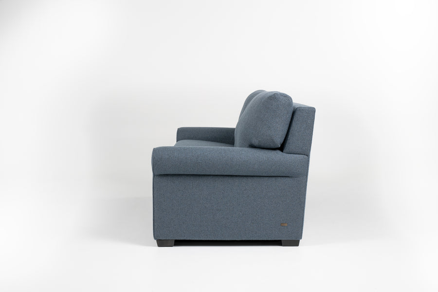 American Leather Gibbs Two Seat Standard (Queen) Comfort Sofa bed in indigo color with high tapered wood legs, left side view.