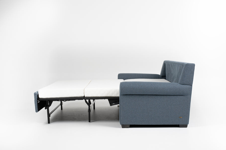 American Leather Gibbs Two Seat Standard (Queen) Comfort Sofa bed in indigo color with high tapered wood legs, left side view, pulled-out.