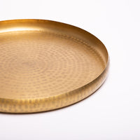 Hand-embossed brass tray.