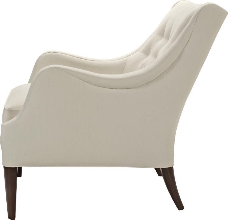 A white Ludlow lounge chair with softly diamond-tufted back resting on elegantly on tapered posts and Dark Walnut finish. Side view.