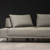 Grey fabric Felix Sectional with moveable back and arm rests and metal legs. Partial view of the left side.