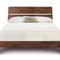 Linn queen size bed crafted from reclaimed walnut hardwood with contemporary design, front view.