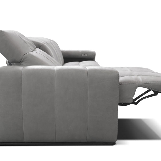 Grey leather 3 seater sofa consisting of 1 left arm, 1 right arm, and 1 armless chair with electric head and footrest. Side view, reclined.