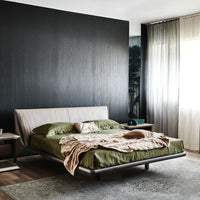 The Nelson designer modern king size bed with a light shape, placed in a modern room, front and side view.