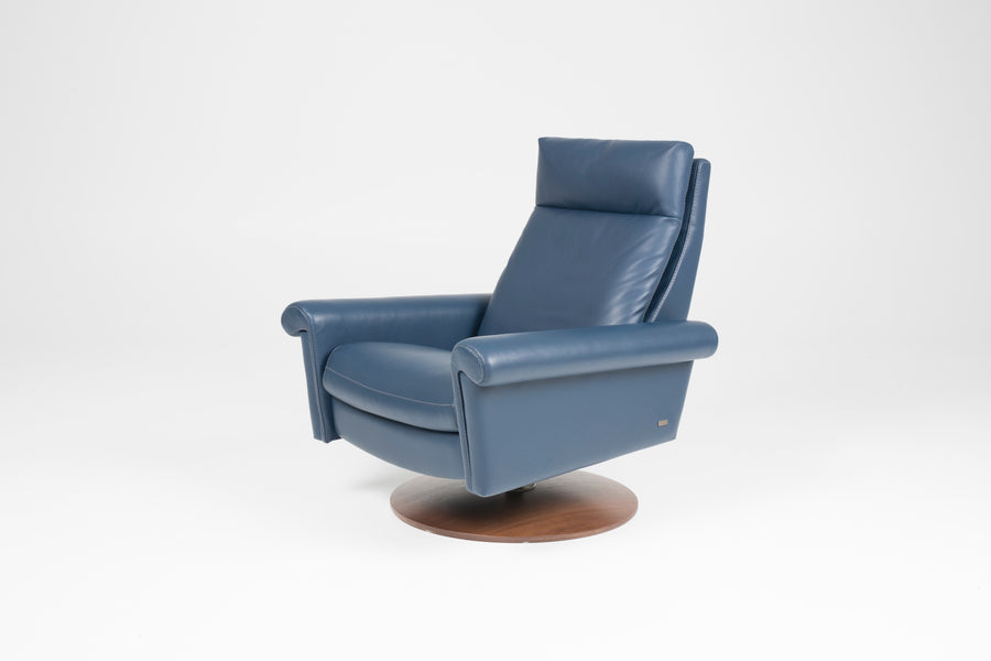 A blue leather Nimbus recliner chair with a disc base in Natural Walnut. Front and side view.