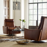 Two brown leather Ontario modern rocking recliner chairs.