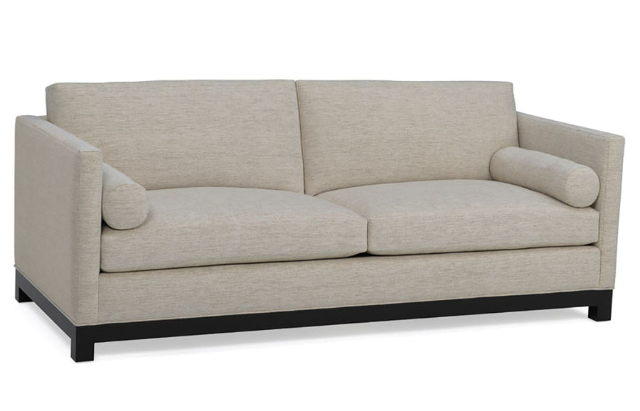 Grey two seat Oscar Sofa that features a slim tuxedo style, foam and down seats, arm bolsters and parson legs. Front view.