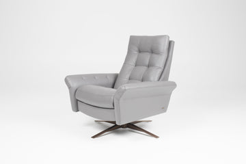 A grey leather recliner chair with buttonless tufted back and seat and four star base.