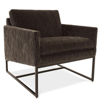 A brown Rebel lounge chair with angled side profile and metal frame.