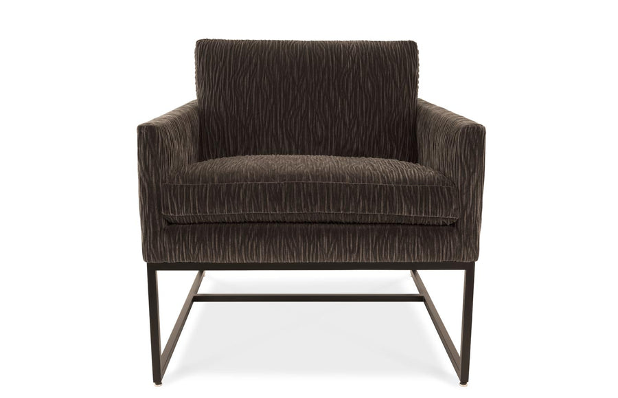 A brown Rebel lounge chair with angled side profile and metal frame, front view.